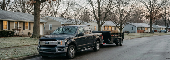 Pack Haul truck and dump trailer parked in a quiet neighborhood during the week before Christmas.